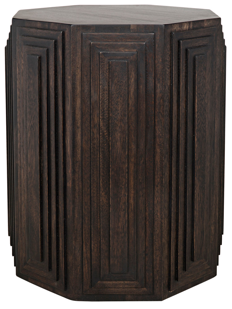The Moore Side Table, Ebony features a dark wooden, octagonal design with vertical geometric layered panels on each side, inspired by handcrafted walnut tables and finished in rich ebony.