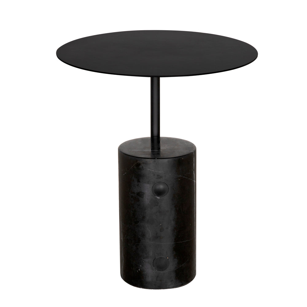 The Juma Side Table features a round, flat black top supported by a slim rod and anchored by a cylindrical black marble base, offering a sleek, contemporary accent to any space.