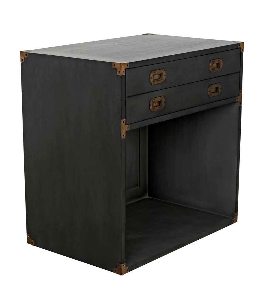 The Campaign Chest, Pale is a dark rectangular wooden side table with two drawers accented by brass handles and corner brackets, plus an open storage space below.