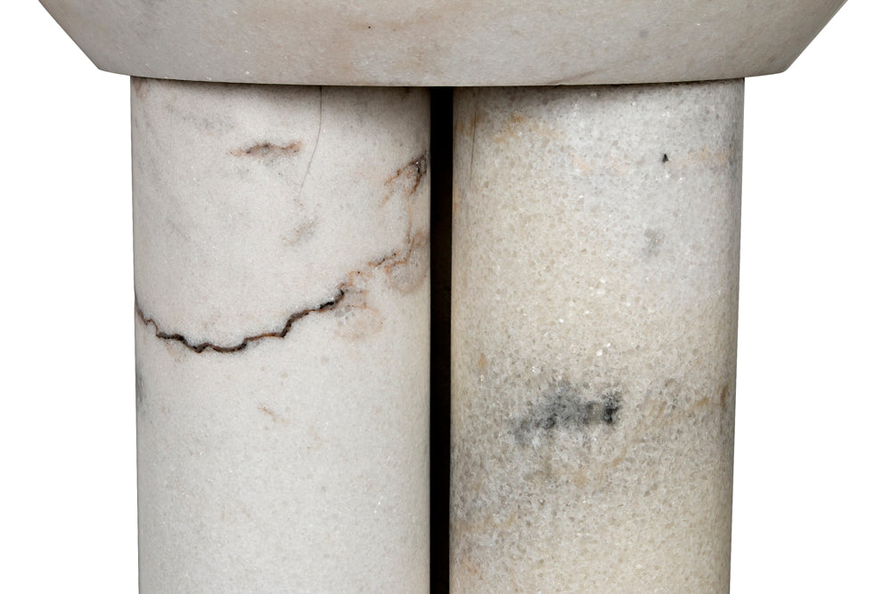Close-up of two cylindrical white marble columns with natural gray and black veining, supporting a flat stone top—highlighting the Nox Side Table's modern elegance and striking marble-finished design.