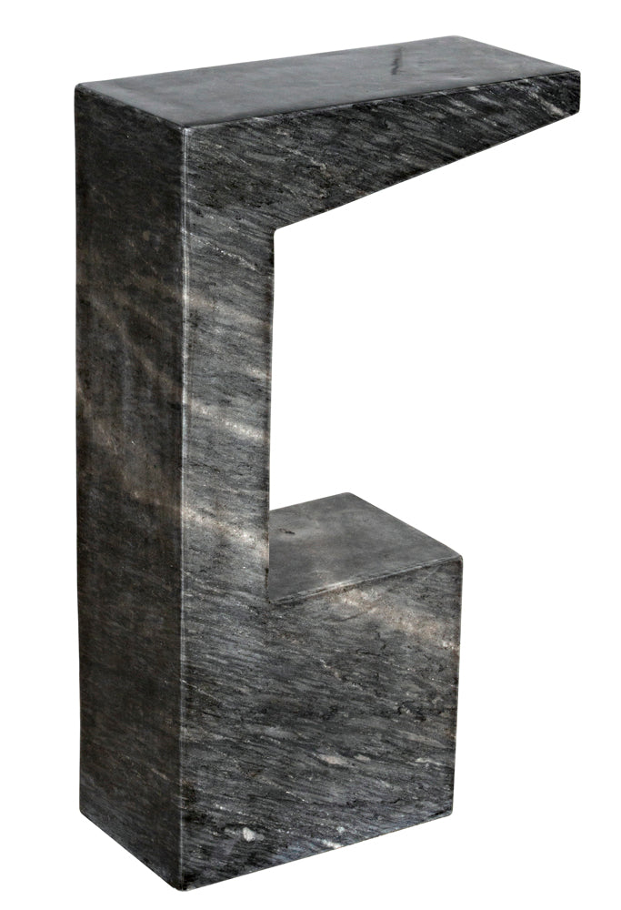 The Aero Side Table, B is a modern, elegant piece crafted from black marble with a sculptural geometric design, flat top, and open space beneath.