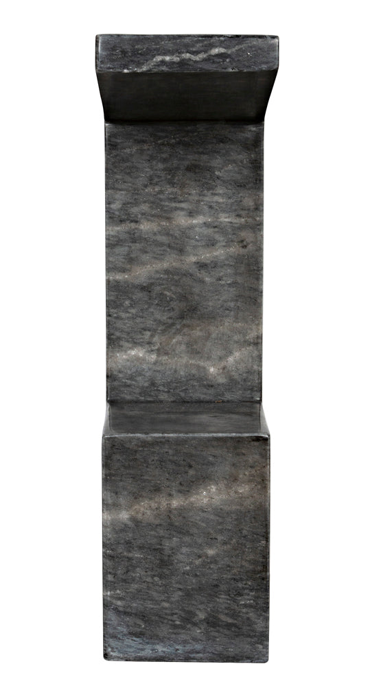 A modern, minimalist chair made of dark gray stone features a solid rectangular base and straight backrest. Its marbled texture pairs perfectly with the Aero Side Table, B in black marble for a sleek, elegant look.