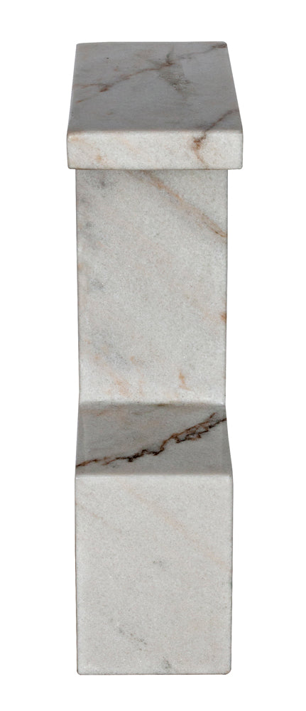 The Aero Side Table features an angular, modern silhouette with a flat top, straight lines, and subtle gray veining on its marble surface.