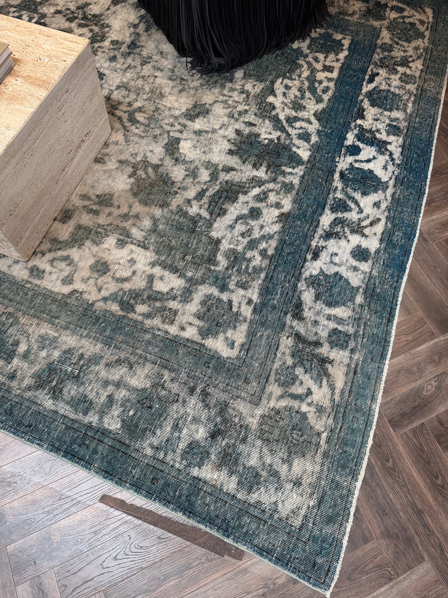 Vintage Blue Distressed Wool Area Rug in blue and cream on a dark wooden floor inside an 8x12 shed.