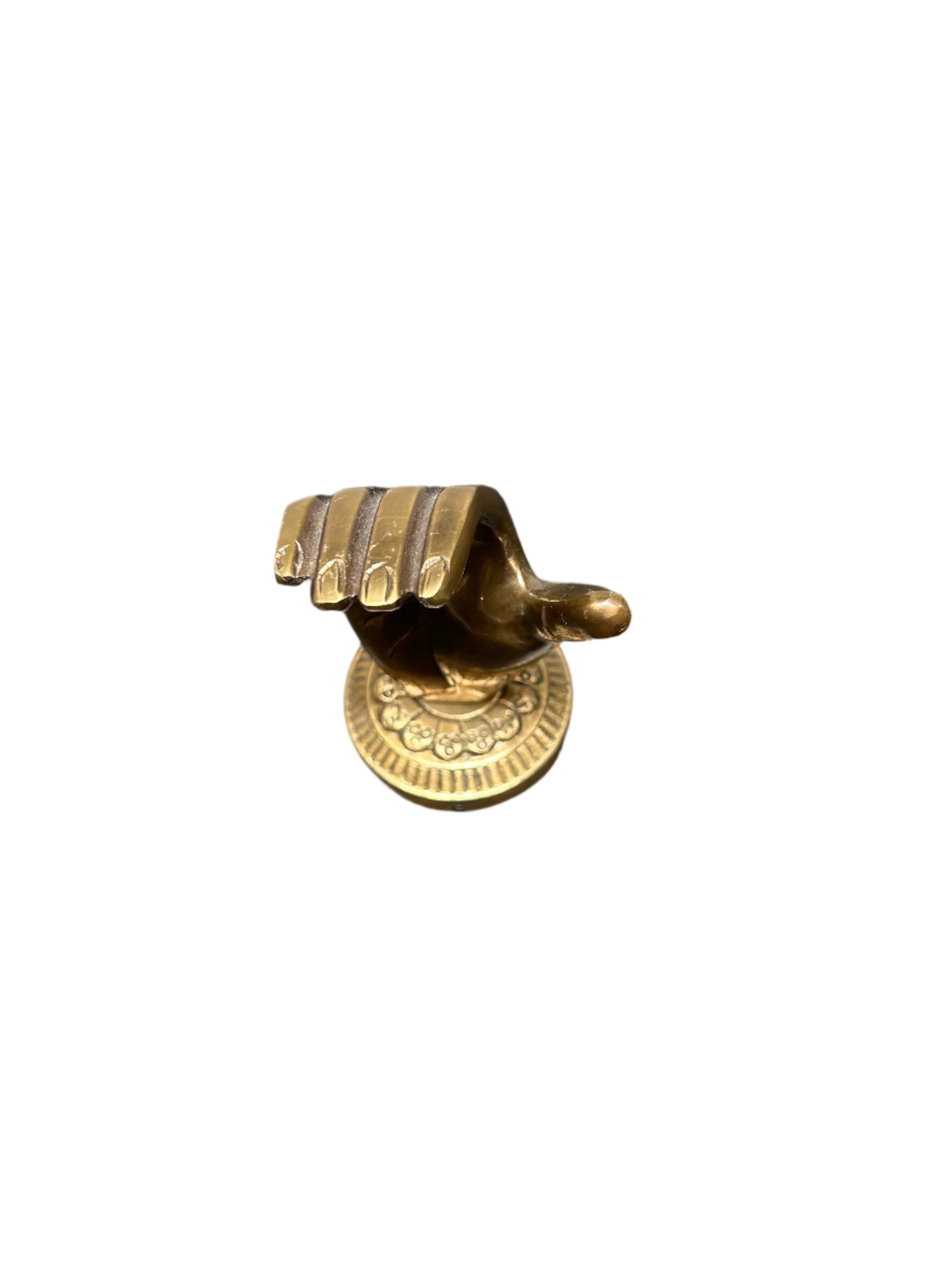 The Brass Hand Object is a gold-tone sculpture with fingers together, pointing downward, mounted on a round ornate base. It measures 4"H x 2.5"W and is displayed against a plain white background.