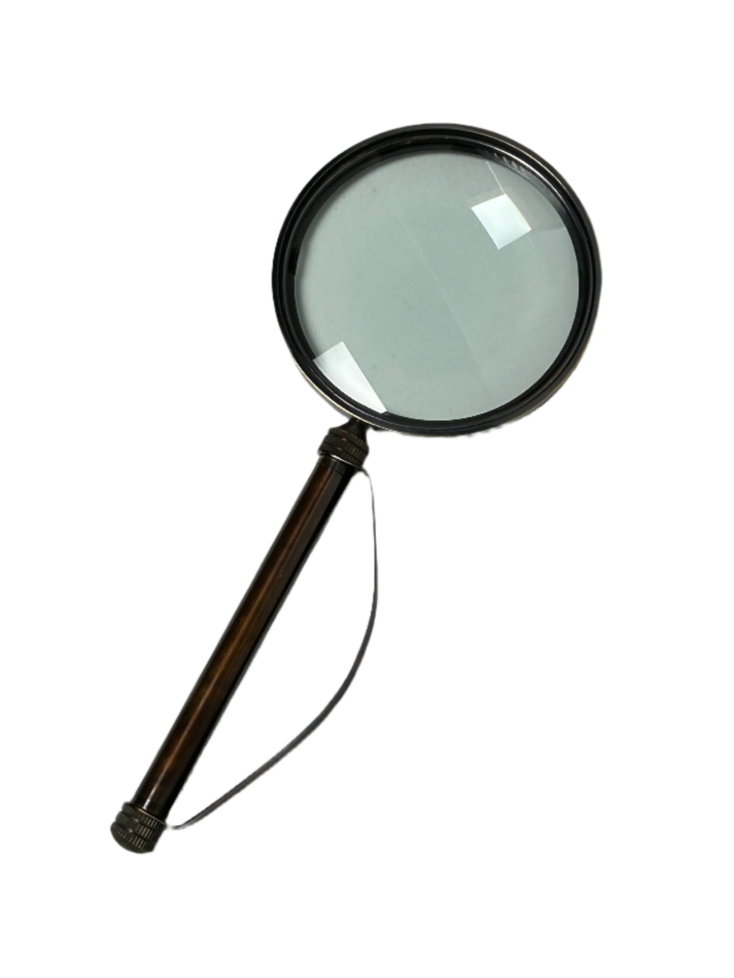 The Brass Strap Magnifying Glass features a round optical glass lens, a dark brown handle, and vintage brass accents, shown isolated on a white background.