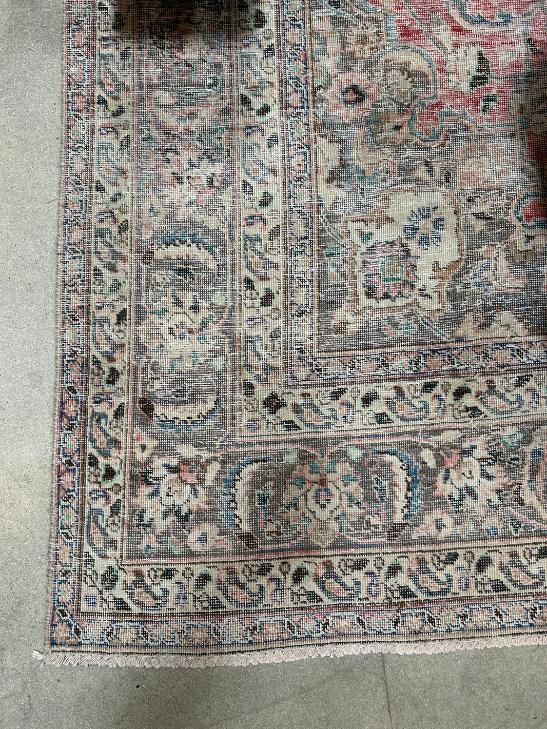 A close-up of the Vintage Area Rug - Ivory/Grey/Pink shows its faded floral and geometric patterns in muted tones, making it ideal for pairing with classic office furniture or placing under an 8-foot desk on a concrete floor.