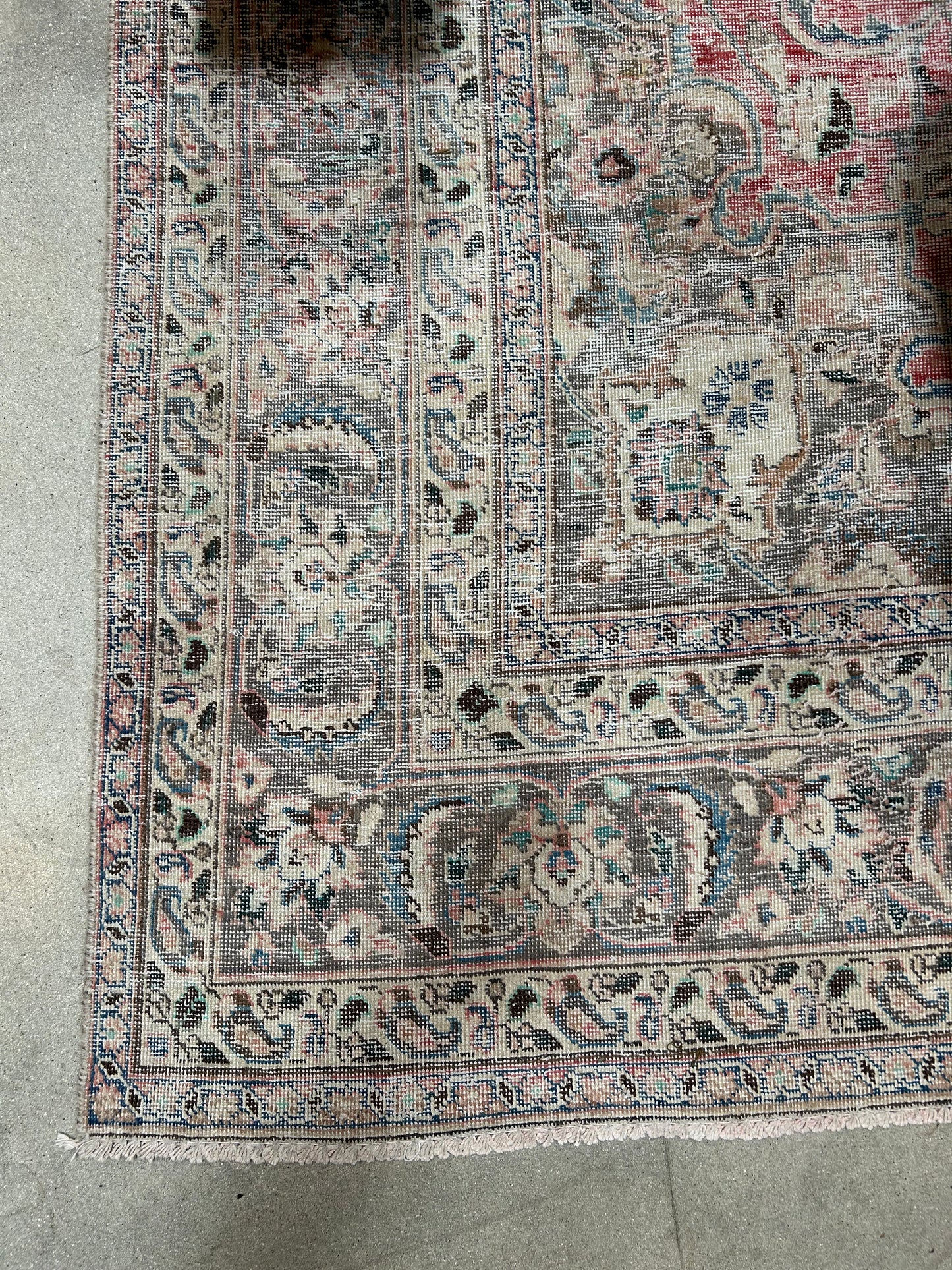 A close-up of the Vintage Area Rug - Ivory/Grey/Pink shows its faded floral and geometric patterns in muted tones, making it ideal for pairing with classic office furniture or placing under an 8-foot desk on a concrete floor.