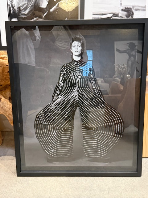 David Bowie - Shadow Box Gallery Print: 32" x 38" framed black-and-white photo of Bowie in a striking, wide-legged costume with bold patterns and raised arms; reflections and other artwork appear in the background.