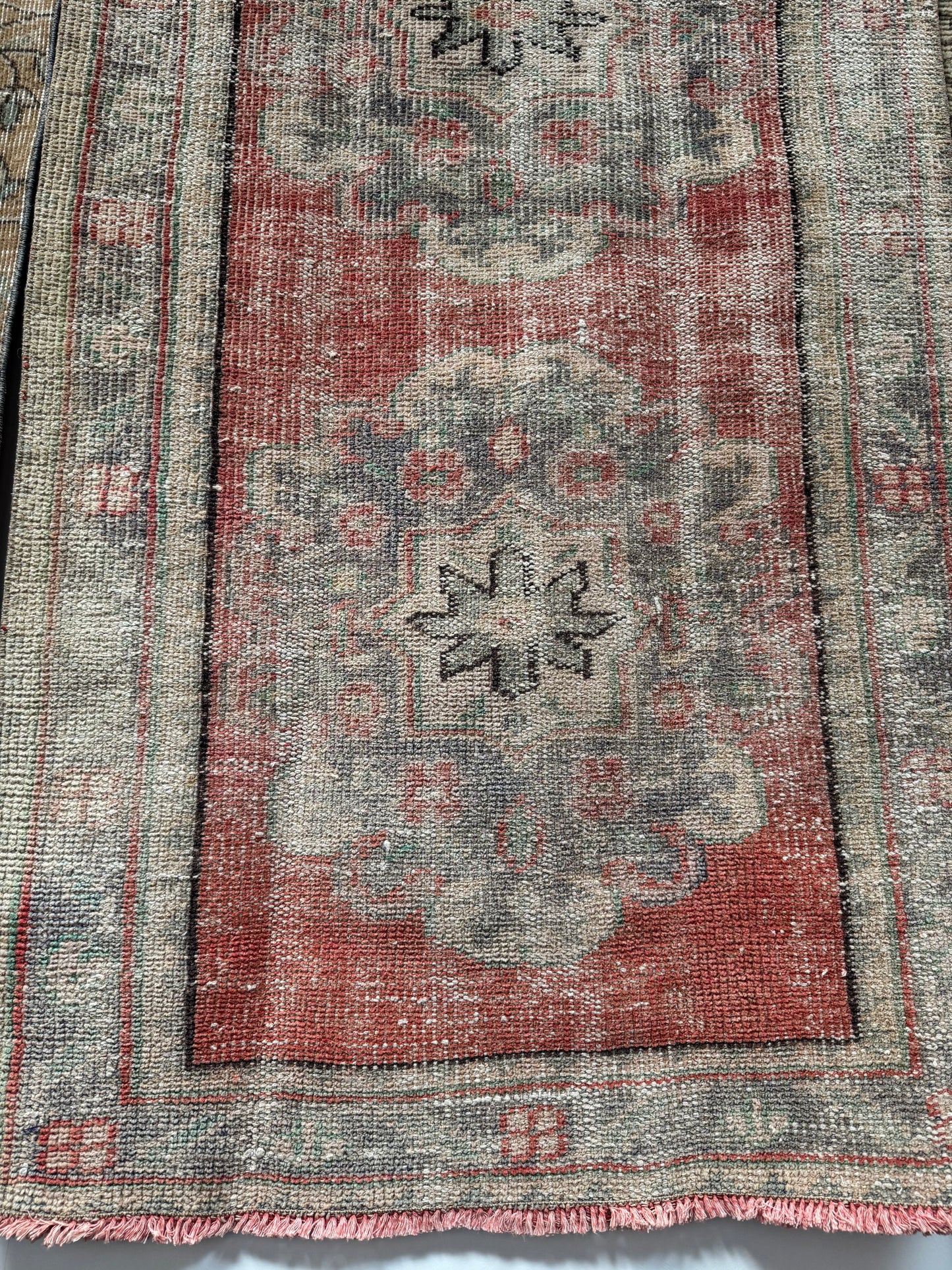 A close-up of the Vintage Turkish Runner Rug showcases its intricate texture and vibrant turquoise color.