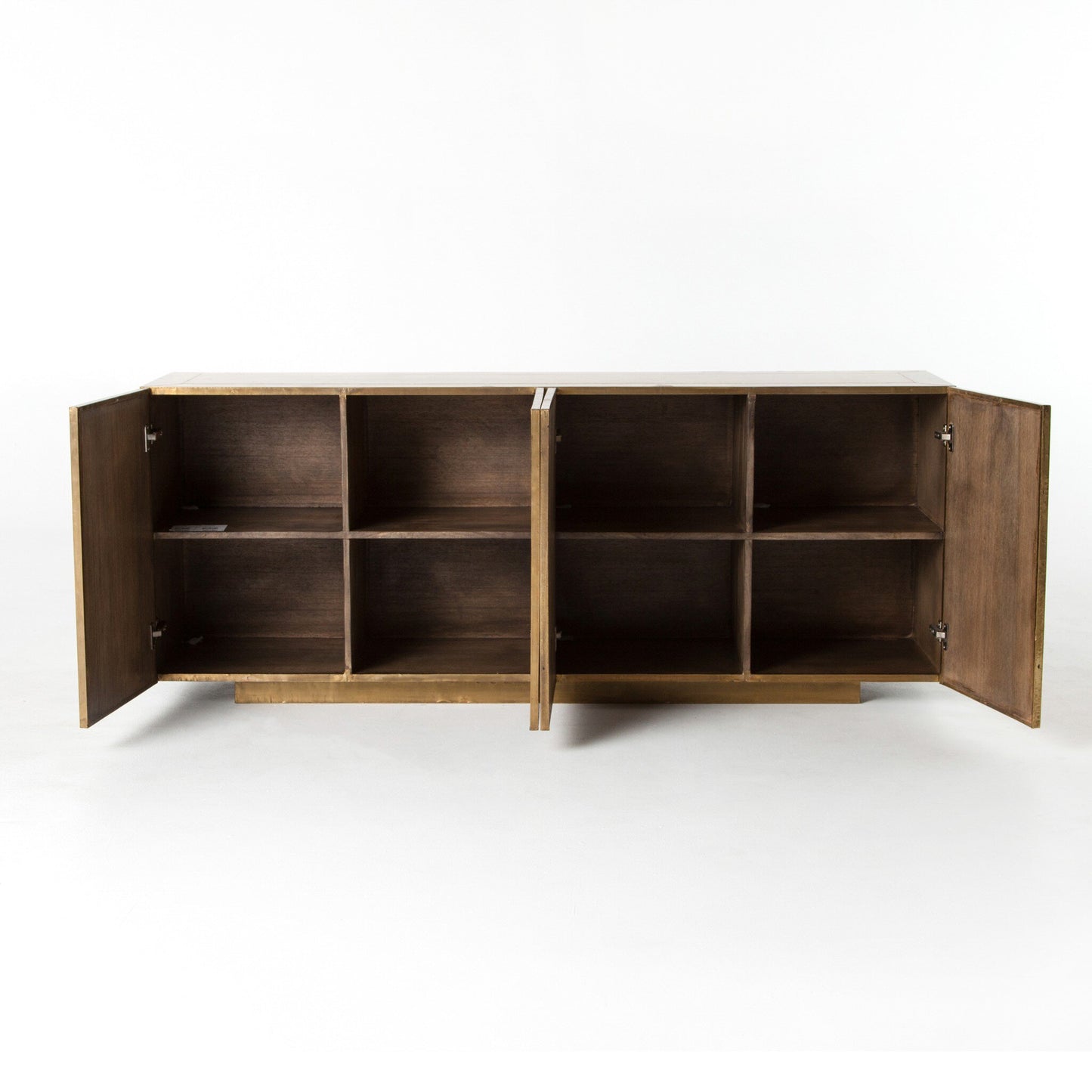 The Brushed Brass Sideboard is a 72"W wooden cabinet with two doors that open to reveal eight square storage compartments, featuring a smooth mango veneer finish and subtle brass accents against a plain white background.