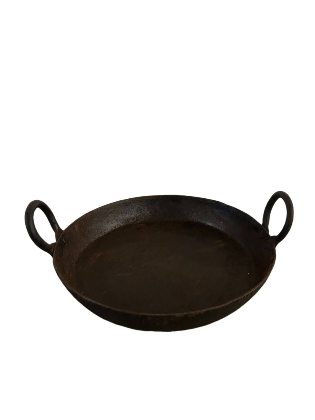 The Iron Skillet with Handles is a round, flat, black iron pan featuring two loop handles on opposite sides and measures 12"-15" wide, shown against a white background.