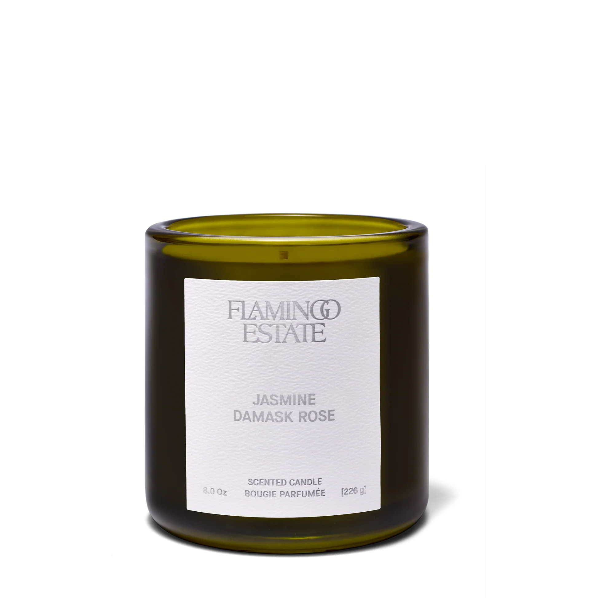 A green glass jar candle with a white label reading Flamingo Estate - Night Blooming Jasmine & Damask Rose Candle, 8.0 oz (226 g), is displayed on a plain white background.