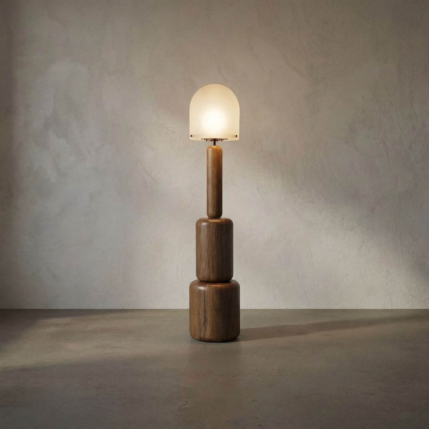 The Totemic Floor Lamp features a geometric wooden base with three stacked cylinders and a frosted glass dome shade, casting a soft glow and offering modern, sculptural style reminiscent of contemporary walnut designs.