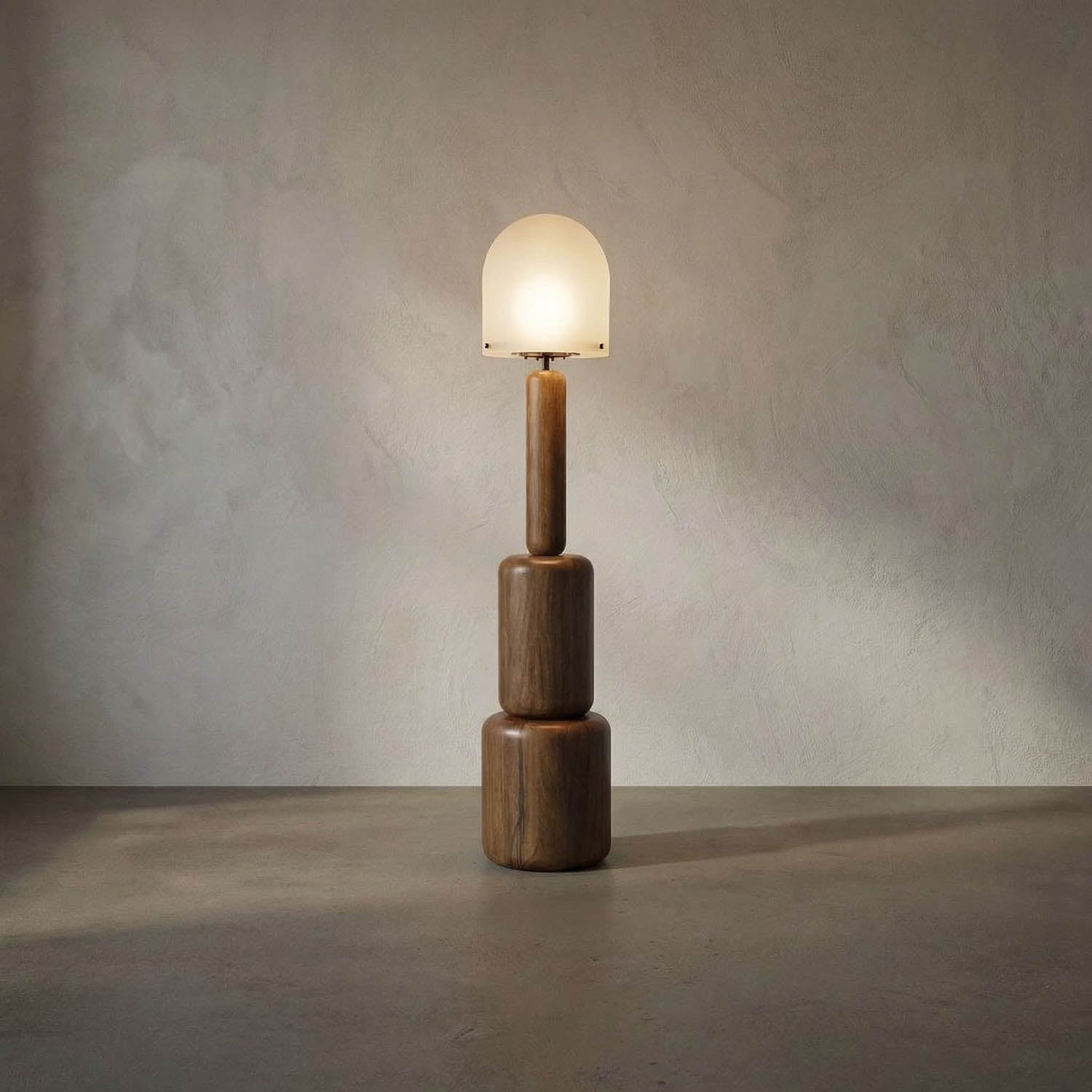 The Totemic Floor Lamp features a geometric wooden base with three stacked cylinders and a frosted glass dome shade, casting a soft glow and offering modern, sculptural style reminiscent of contemporary walnut designs.