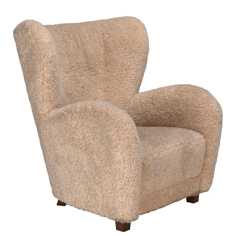 The Pola Chair is a cozy beige lounge chair with wooden legs, perfect for adding comfort and style to any room.