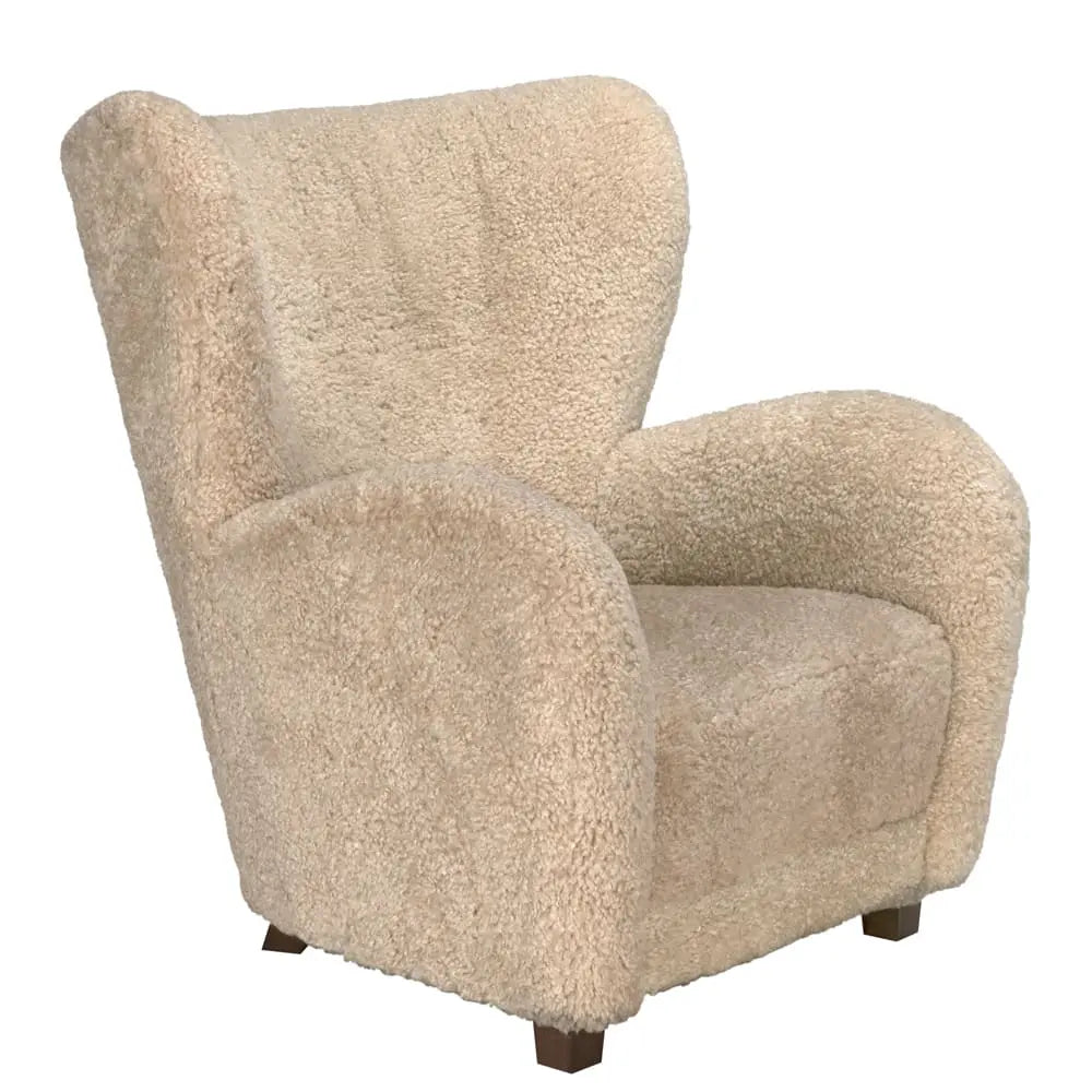 The Teddy Fleece Arm Chair features plush, textured beige fabric, curved armrests, and short dark wooden legs. Its cozy 34W x 36D x 40H design is ideal for snug corners or stylish living rooms.