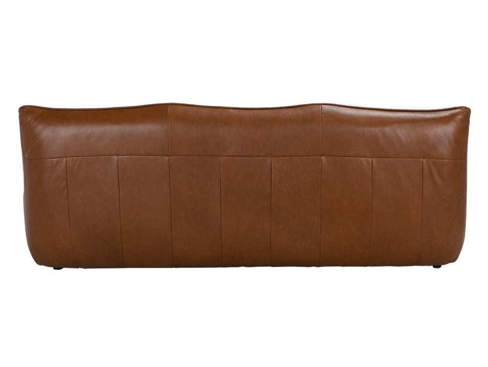 A back view of the McCLAIN 3 SEATER in Roche Tan Leather, featuring a slightly curved, cushioned top edge and vertical stitching details.