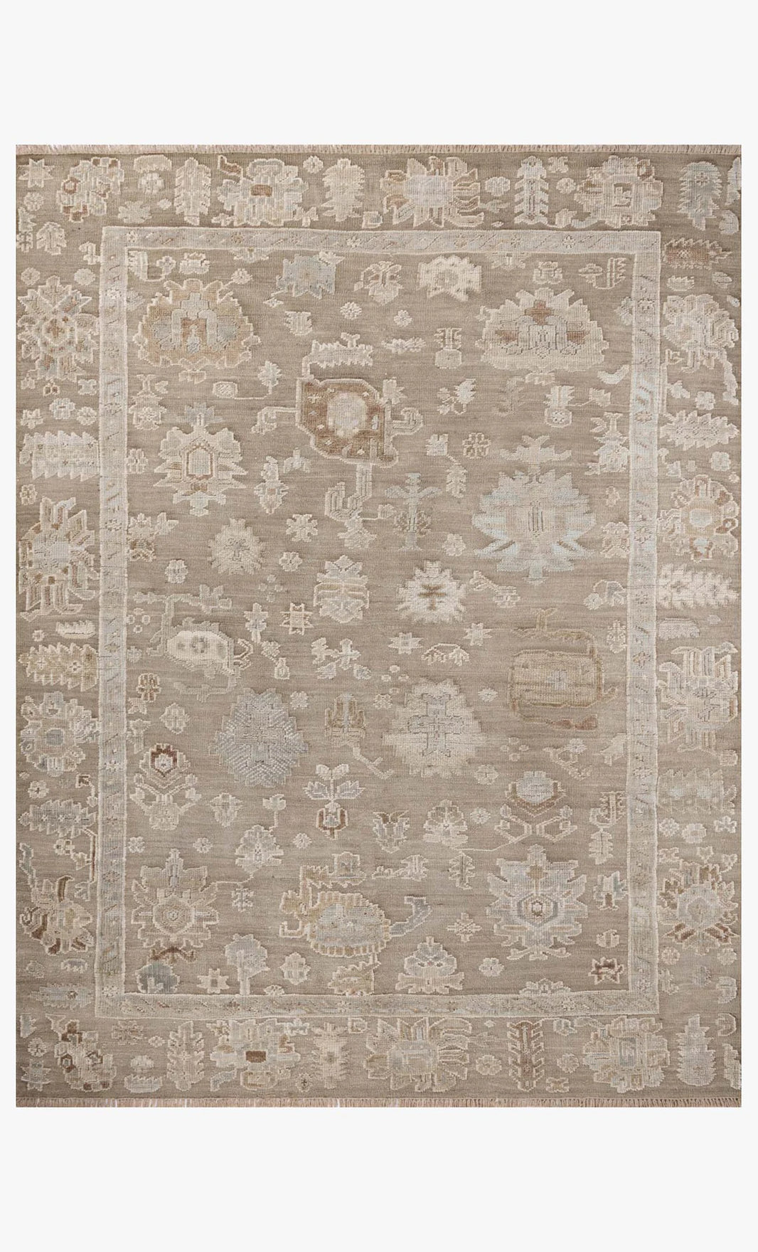 The Pebble Rug 8'-6" x 11'-6" is a rectangular beige area rug made of cotton and wool, with a subtle border and abstract floral patterns in light cream, taupe, and gray.