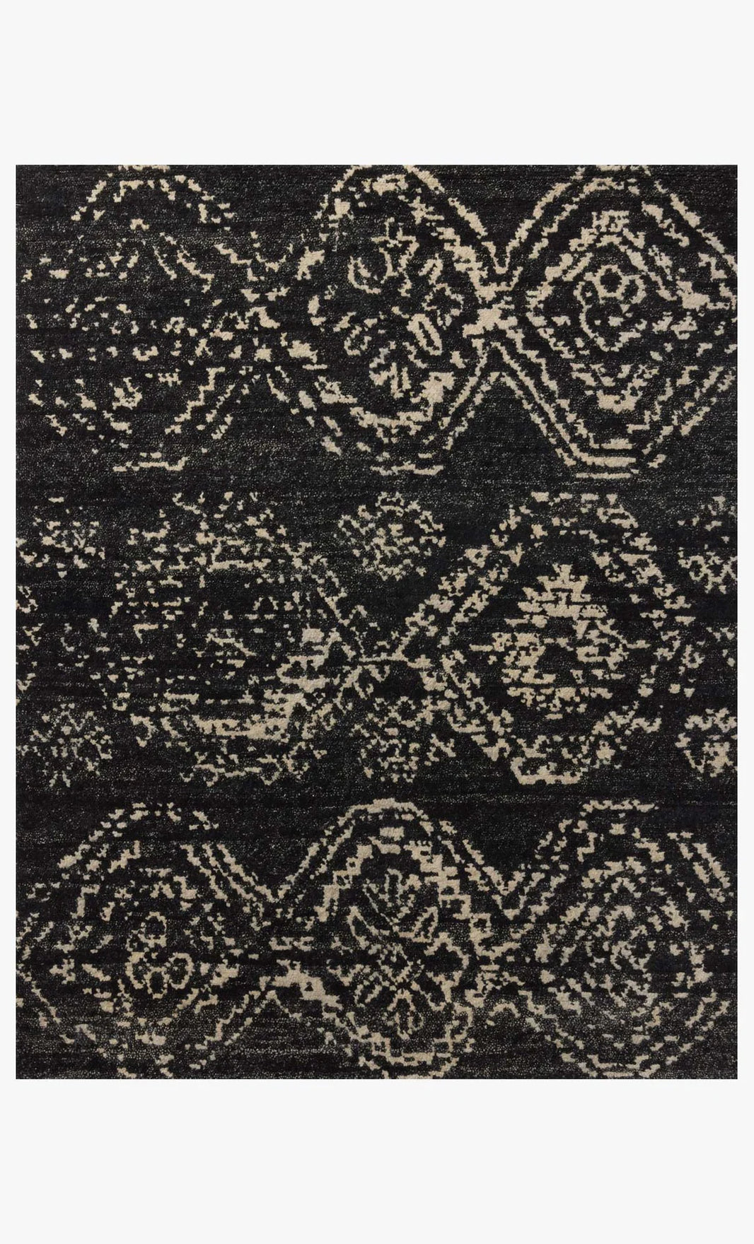 The Abstract Diamond Wool Rug 8 x 10 features a hand-knotted, symmetrical design with geometric diamonds and floral motifs in black and beige, offering a textured, distressed vintage look.