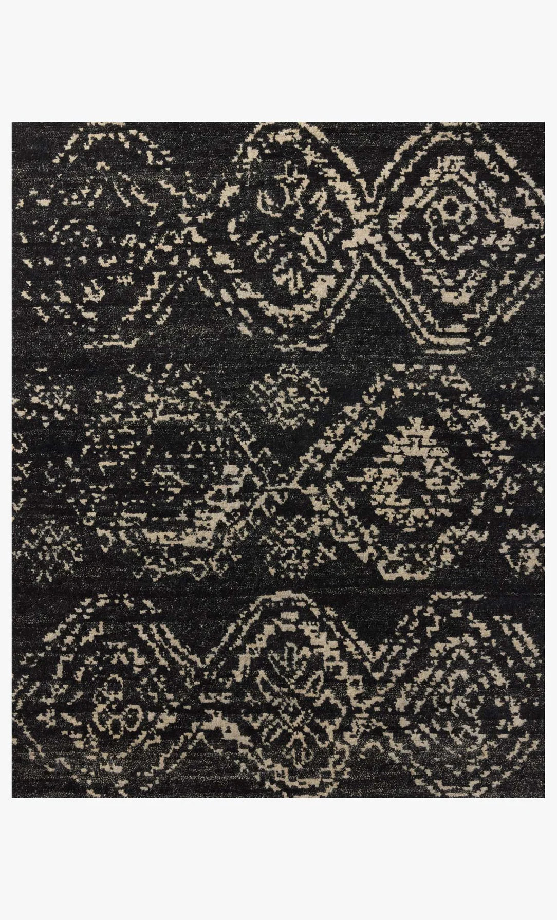The Abstract Diamond Wool Rug 8 x 10 features a hand-knotted, symmetrical design with geometric diamonds and floral motifs in black and beige, offering a textured, distressed vintage look.