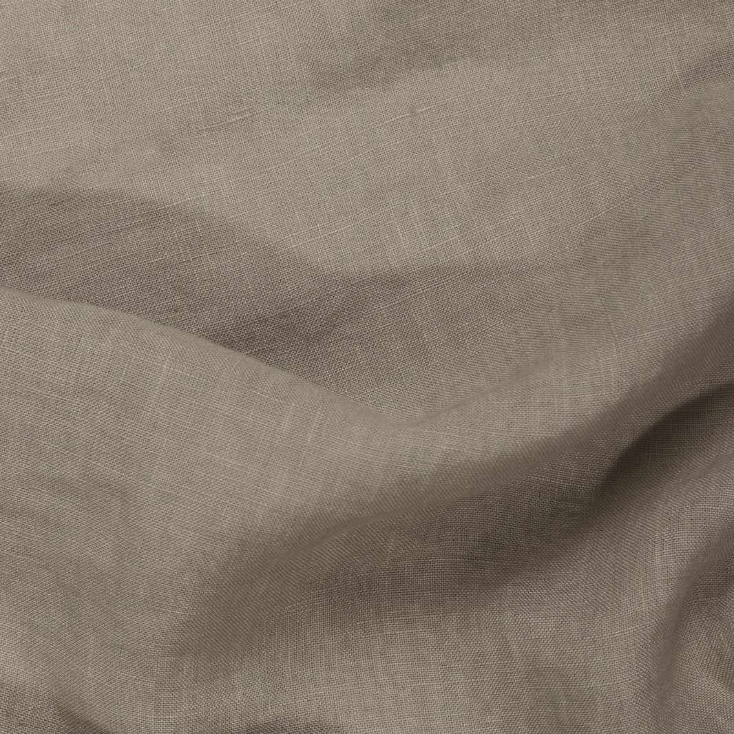 Close-up of Riviera Cotton Bath Towel in Oat, featuring visible texture and weave pattern with gentle folds—an ideal example of garment-dyed cotton towels crafted using non-toxic dyes.