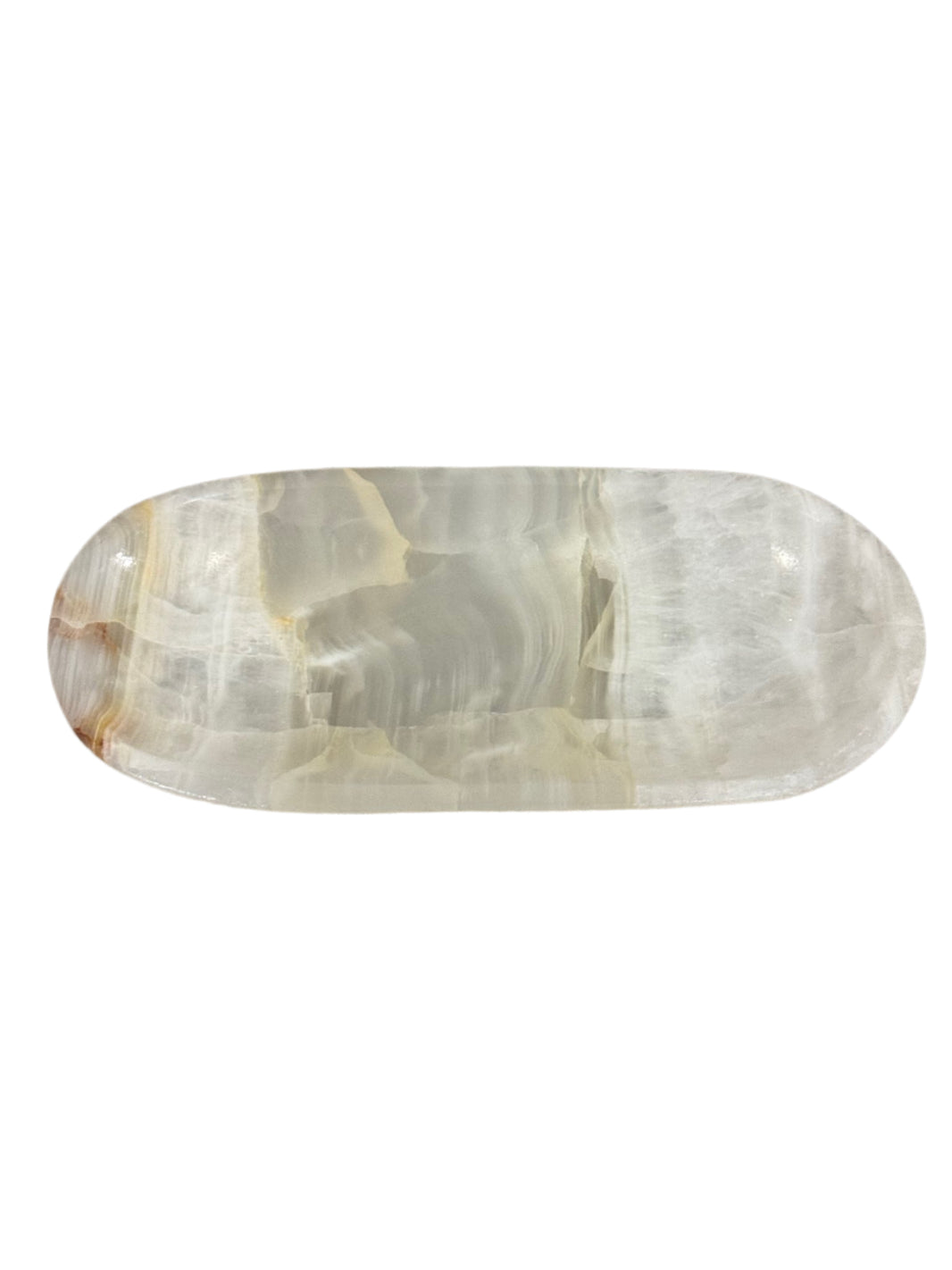 The Small Oval Onyx Tray is a polished, natural onyx dish with an oval shape and smooth surface, showcasing subtle white, beige, and light brown streaks—an elegant accent piece for refined décor.