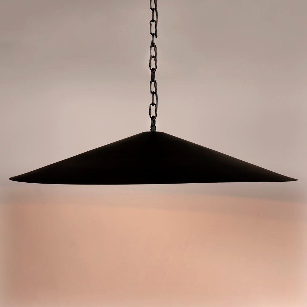 The Matte Black Industrial Pendant features a wide, cone-shaped design hanging from a chain, casting a soft, warm glow—perfect for adding functional lighting and stylish accent to any modern space.
