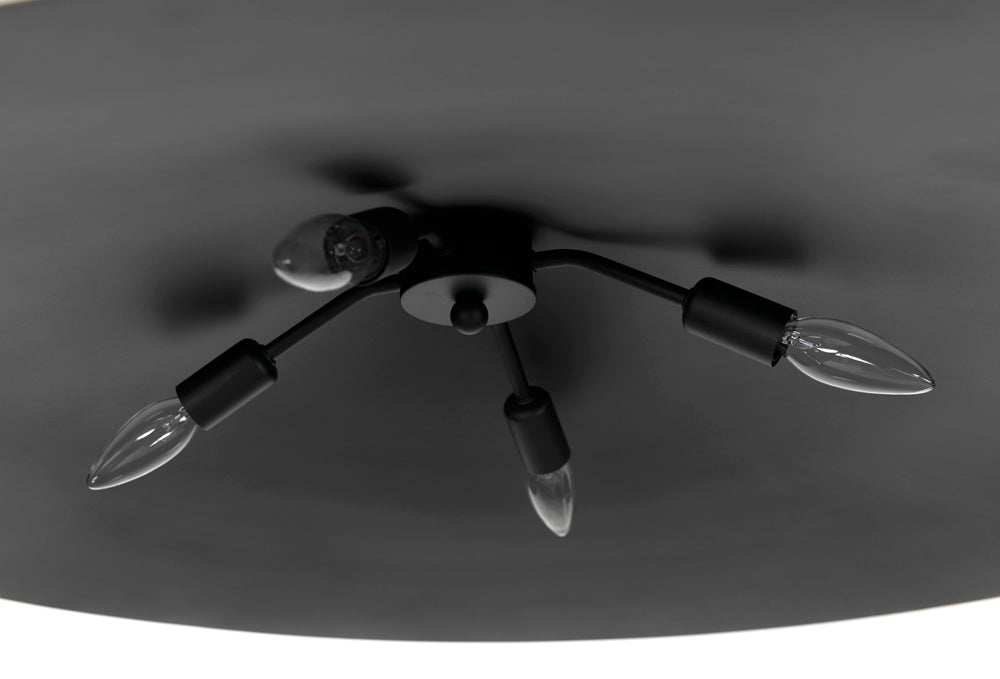 A close-up of the Matte Black Industrial Pendant, a modern ceiling light with four exposed bulb sockets—three featuring clear candle-shaped bulbs and one empty—serves as a stylish accent against a dark ceiling background.