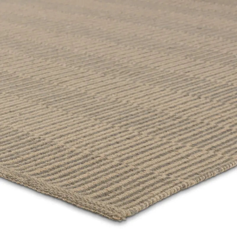 Close-up of the Handwoven Beige Rug, a flat-weave with a subtle textured linear pattern and thin profile. Measures 6'x7' and is shown on a white background.