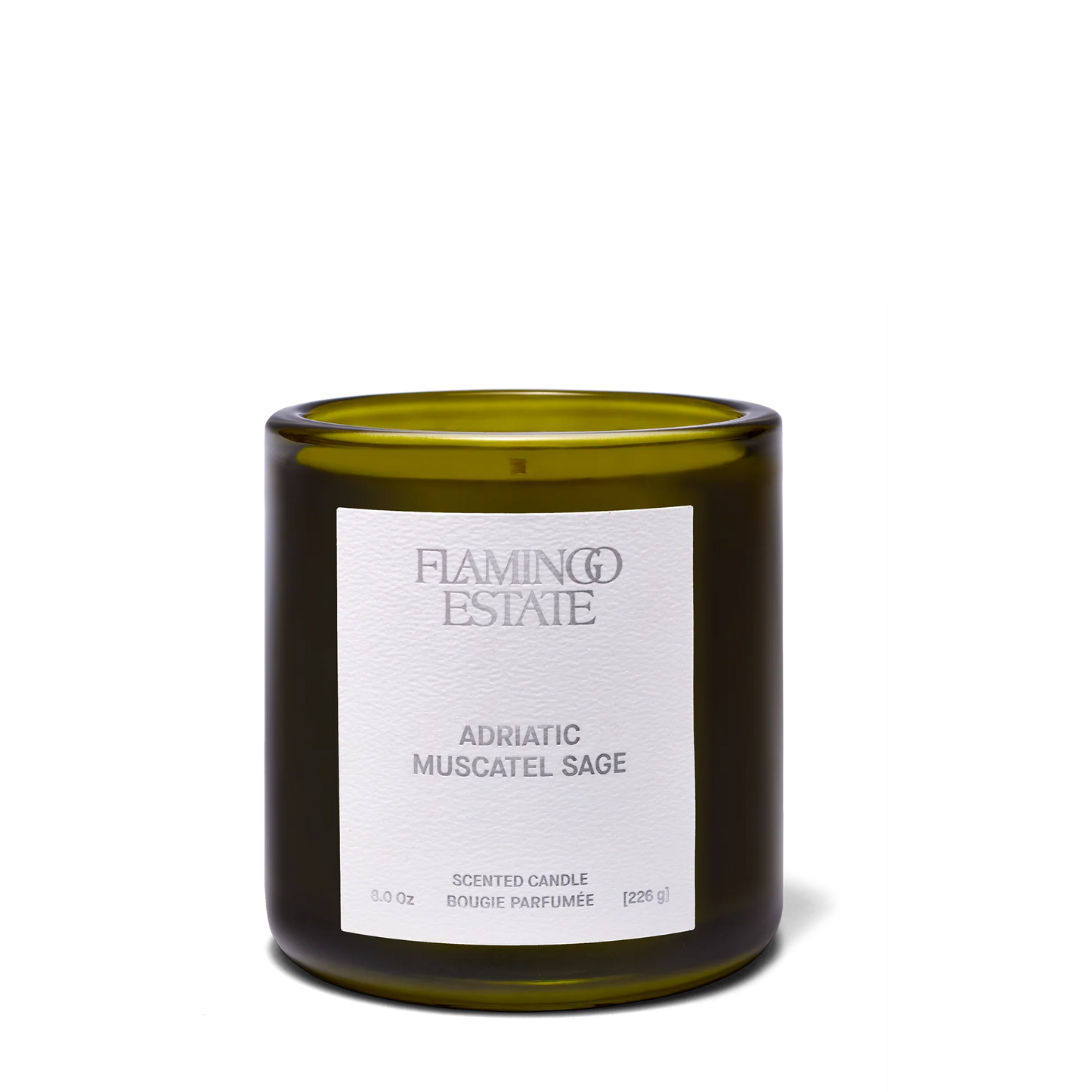 A green glass Flamingo Estate -Adriatic Muscatel Sage Candle sits on a plain white background, filling the air with the herbal scent of California sage.