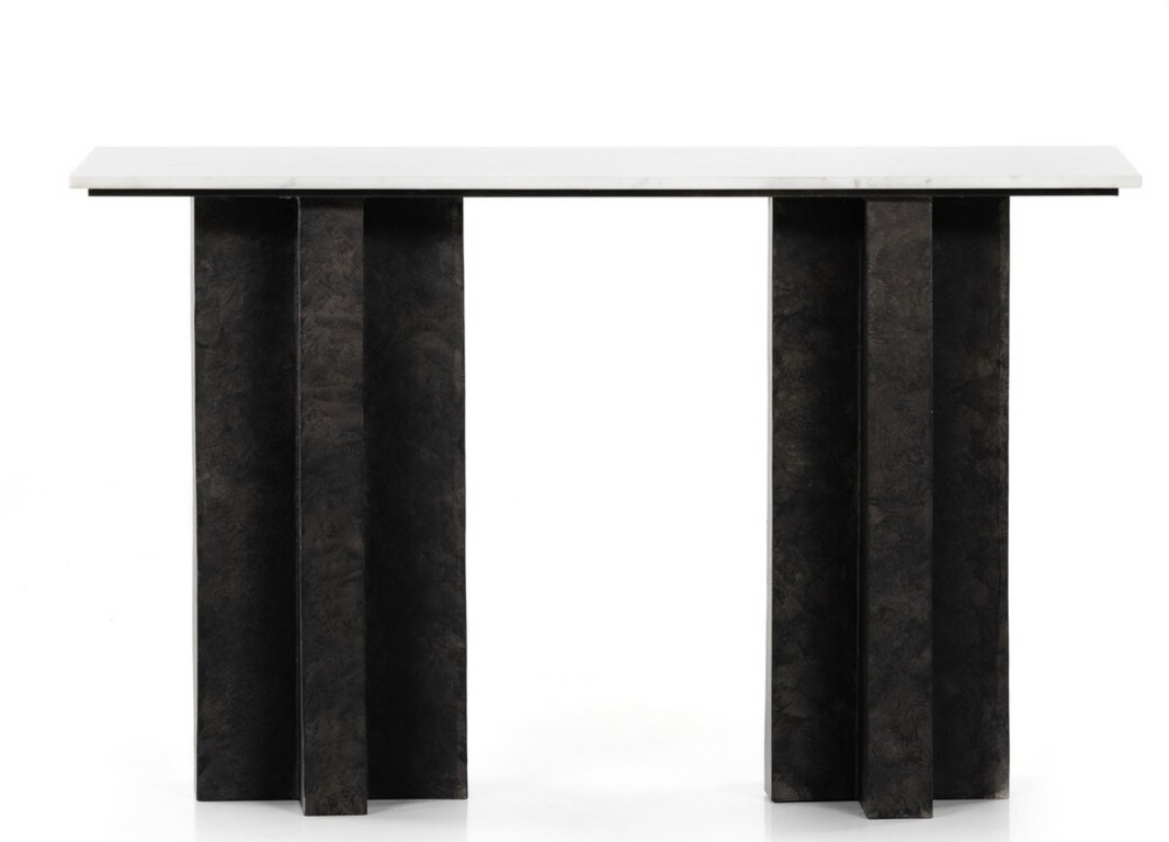 The Marble Raw Black Console Table features a rectangular top and four wide, vertically oriented cast aluminum legs with a textured black finish. Its minimalist, geometric design stands out against a plain white background.