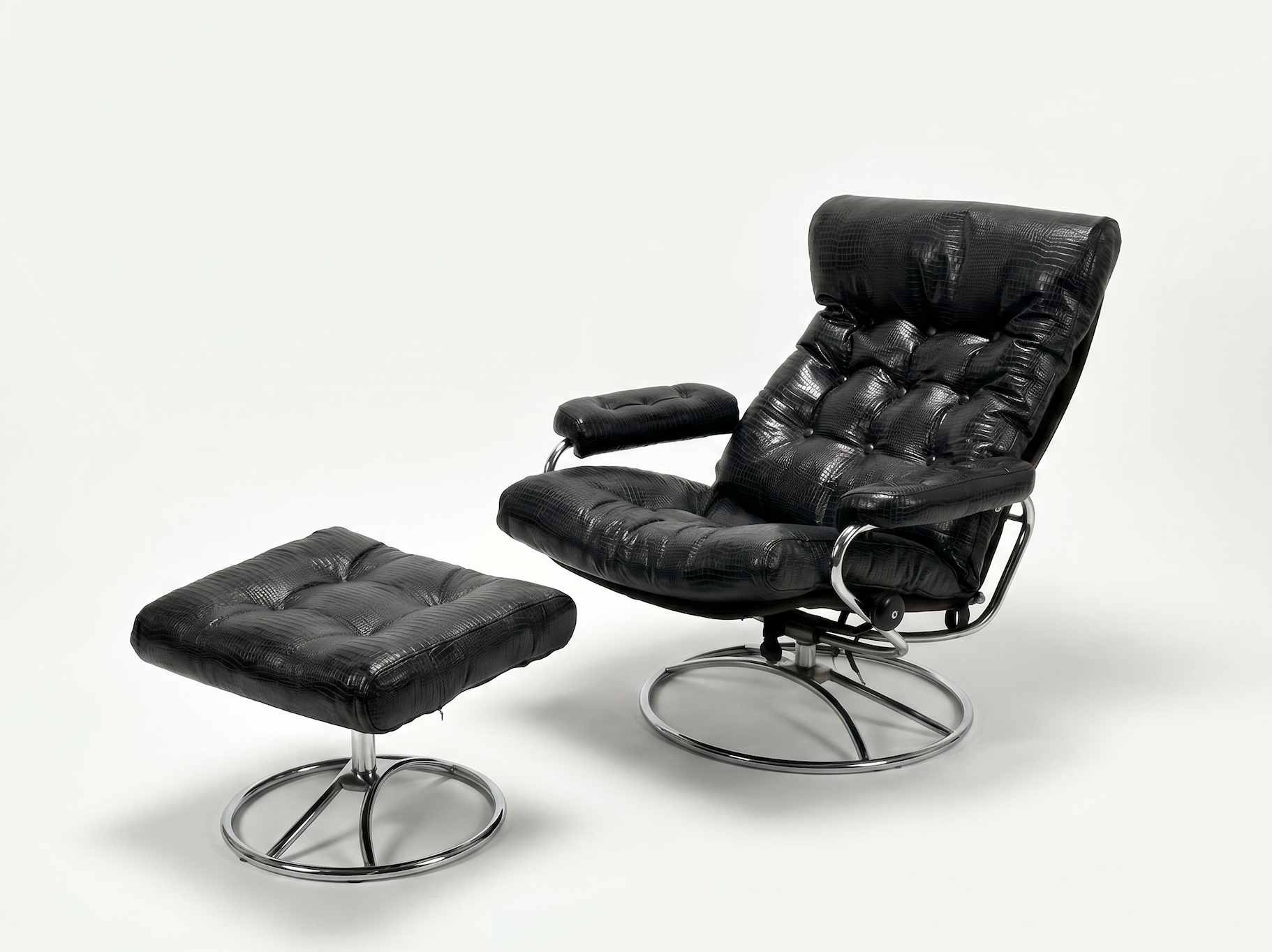 The Vintage Chrome and Leather Recliner & Ottoman features modern black croc leather, tufted cushions, and chrome metal bases, with both pieces displayed against a plain white background.