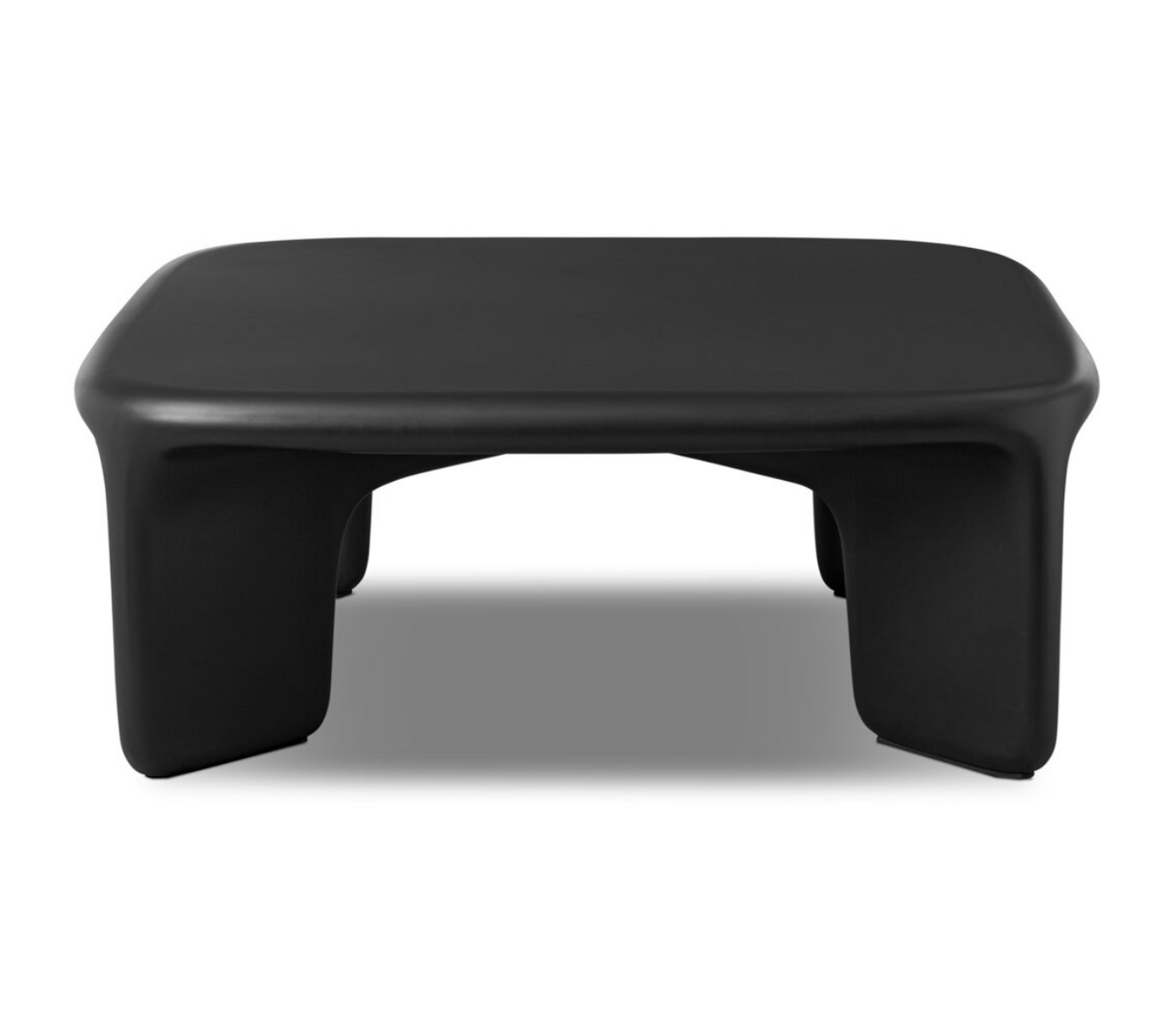The Dante Coffee Table is a low, black, minimalist piece with a smooth, rounded rectangular top and four thick, curved legs.
