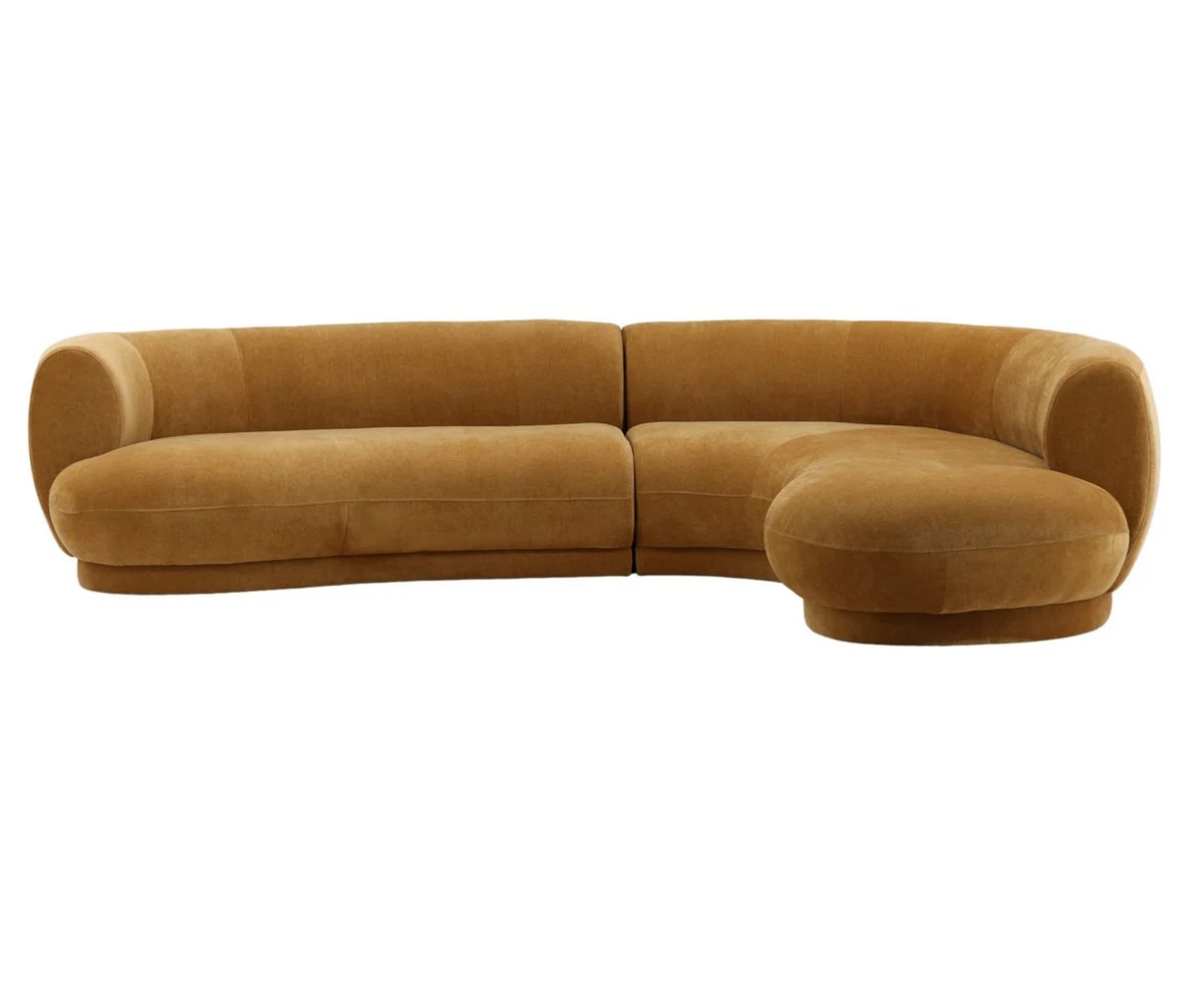 The Forma Chaise Sectional is a large, curved, mustard-colored sofa with a rounded chaise end.