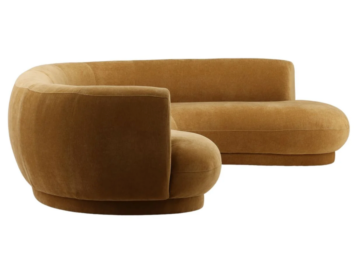 The Forma Chaise Sectional is a curved golden-brown sofa with a low back and a rounded chaise end.
