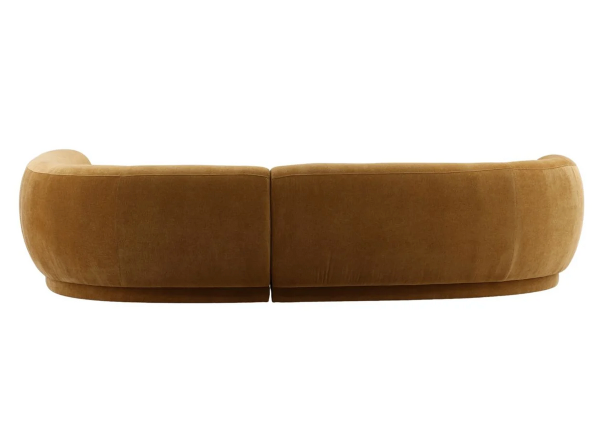 Back view of The Forma Chaise Sectional, a large, mustard-colored sofa with a curved silhouette.