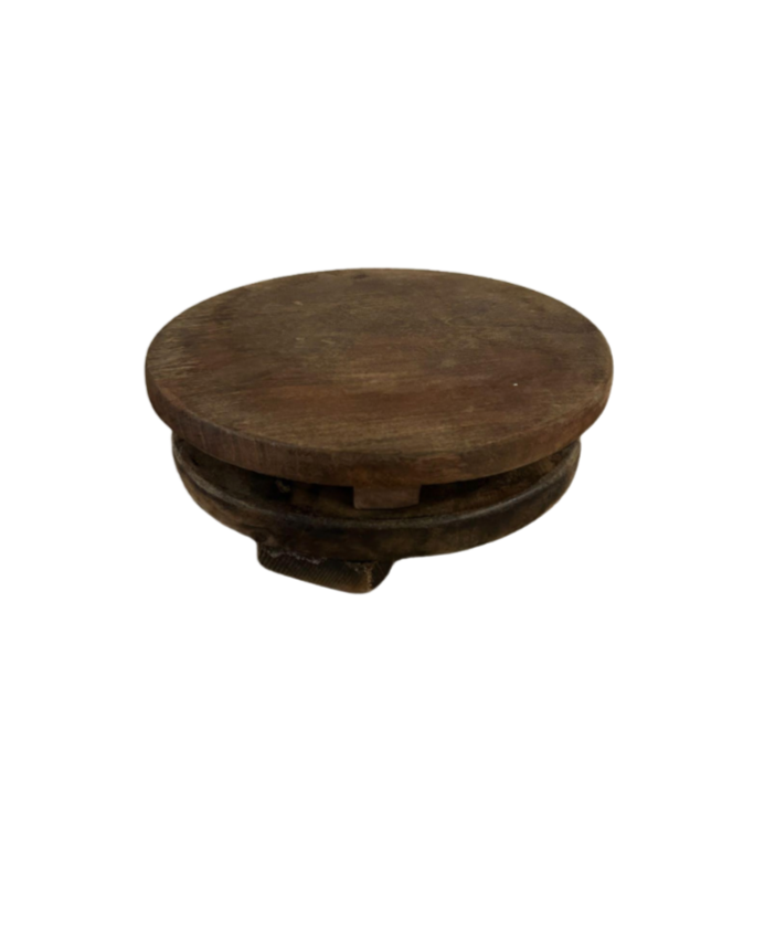 The Dark Wood Riser, a round and flat wooden piece with a thick base and 10-inch diameter, is displayed on a white background.
