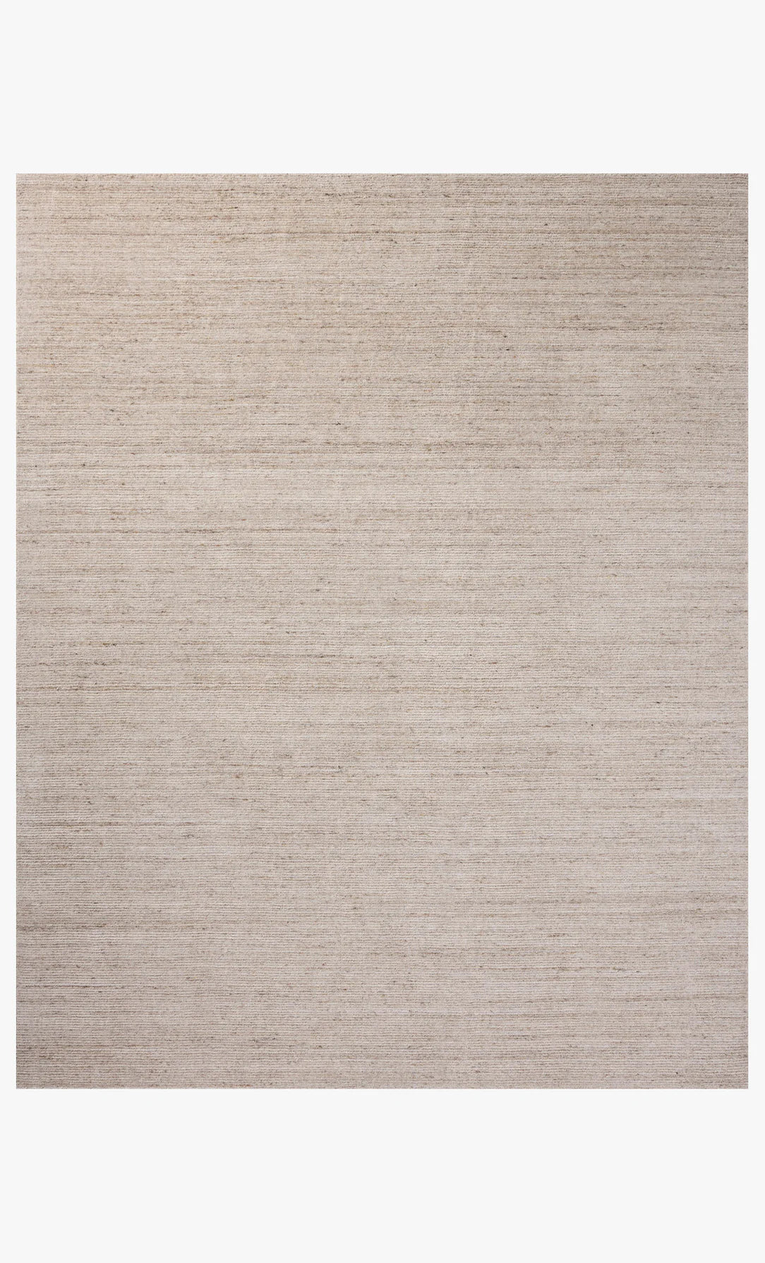 The Color Block Rug, measuring 8'-6" x 11'-6", features a light beige rectangular design with a subtle woven texture and soft polyester pile. It is shown on a white background and comes in multiple sizes.