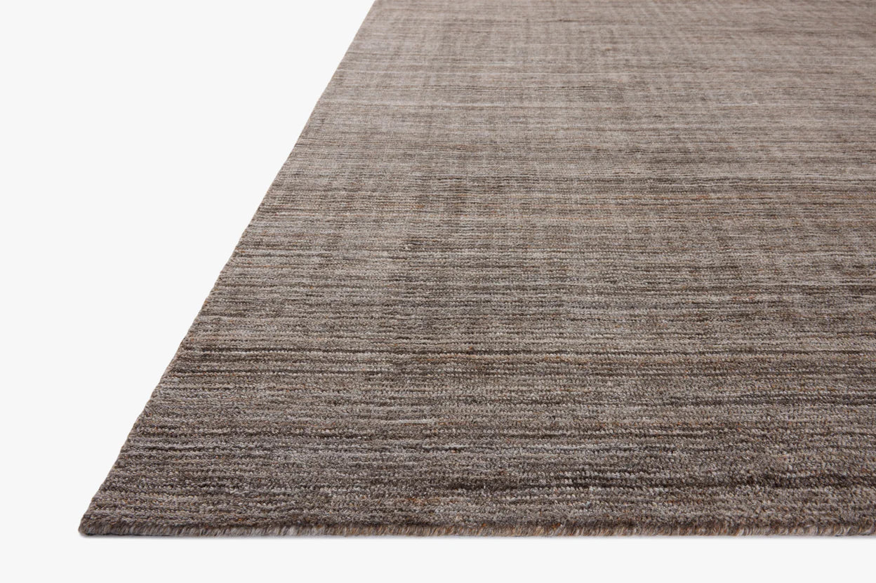 Close-up of the Color Block Rug (8'-6" x 11'-6") showing its textured gray-brown polyester pile on a white background. Available in various sizes.