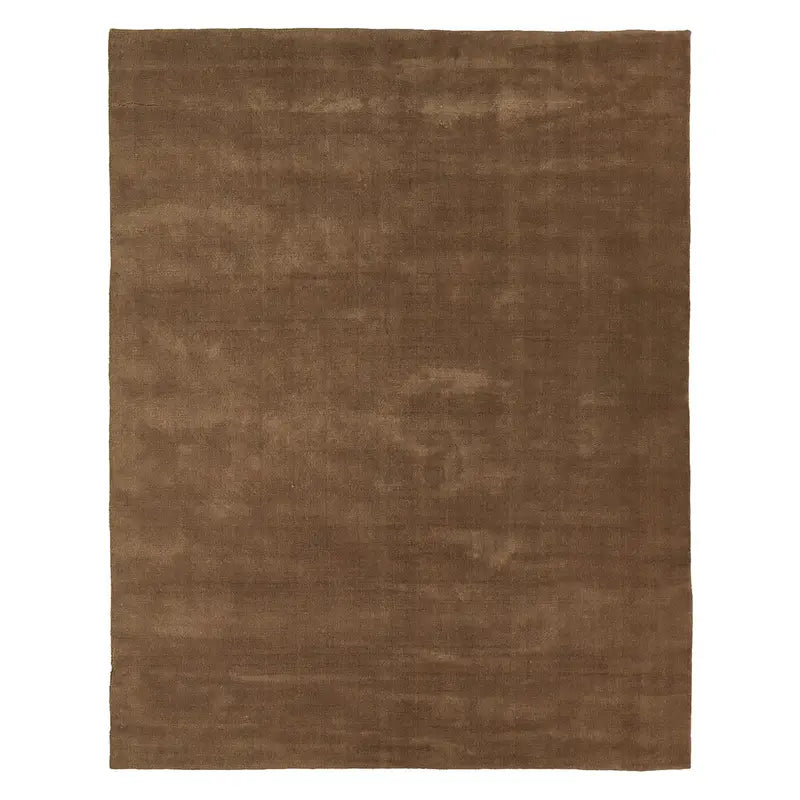 The Handwoven New Zealand Wool Rug features a plain, rectangular 8x10 design in brown with a subtle, slightly uneven texture. Made from high-quality New Zealand wool, this soft rug is free of patterns or designs, making it an ideal choice for both home and office spaces.