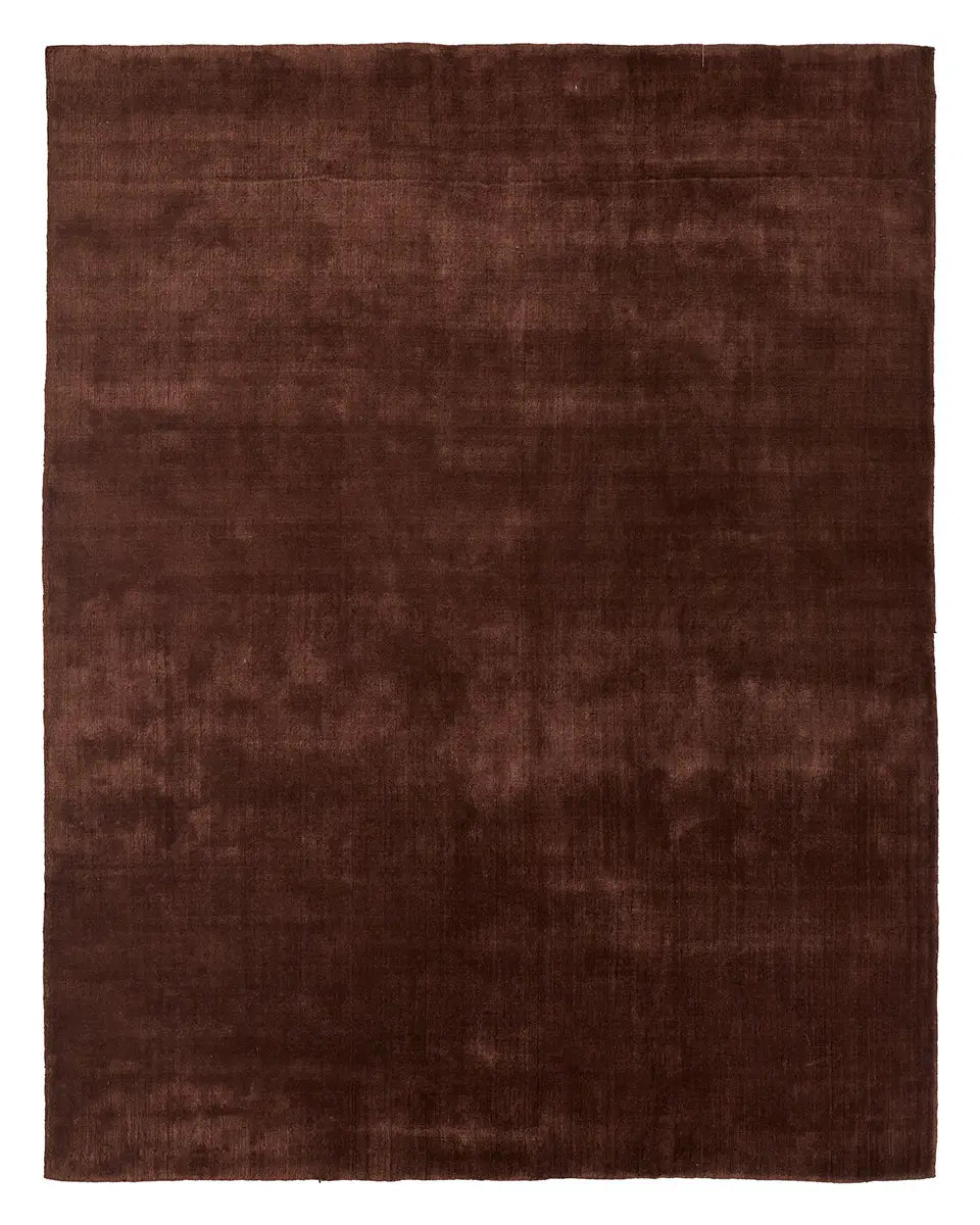 Here’s a revised version using your product data: The Handwoven New Zealand Wool Rug is a rectangular 8x10 rug in a rich, solid deep brown hue, featuring a subtle, slightly textured surface and expertly crafted from premium New Zealand wool.
