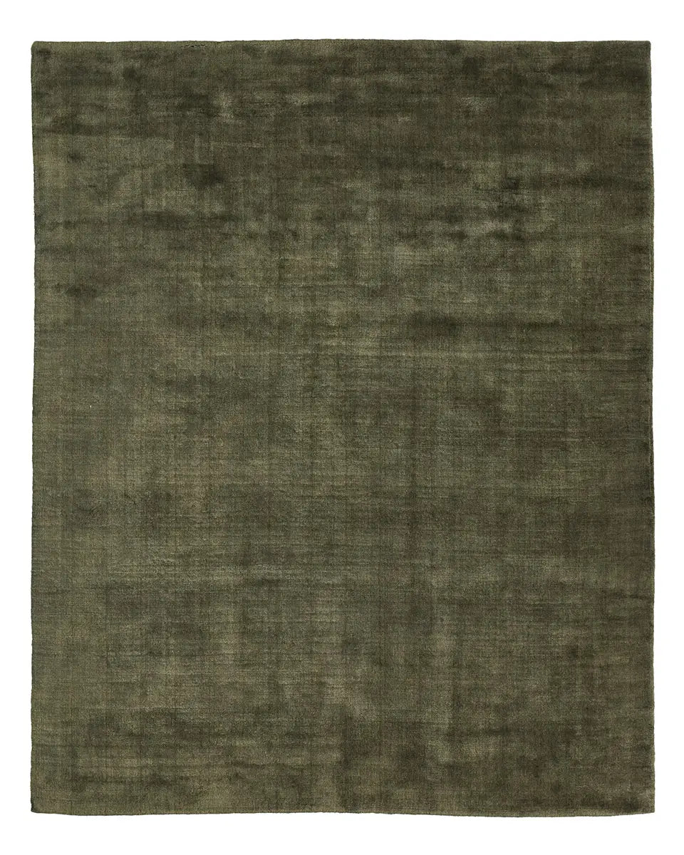 The Handwoven New Zealand Wool Rug is an 8x10 square rug in dark green, featuring a soft, velvety texture. Its plain surface displays subtle mottling and slight variations in shade for a rich and elegant appearance. Expertly crafted from premium New Zealand wool, this rug is free of any patterns or designs.