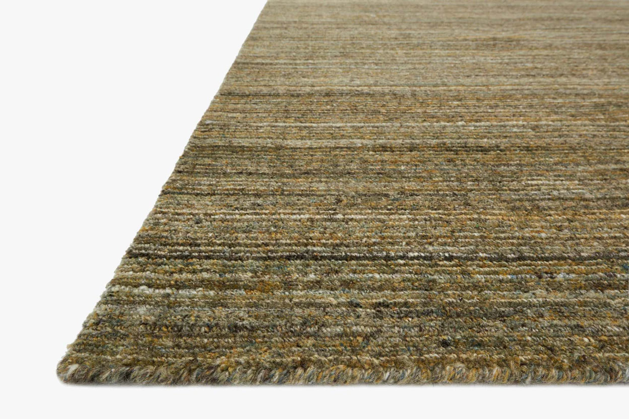 A close-up of the Striated Wool Rug Collection 8'6 x11'6 shows its textured, hand-loomed surface in earthy brown, green, and gray tones against a white background.