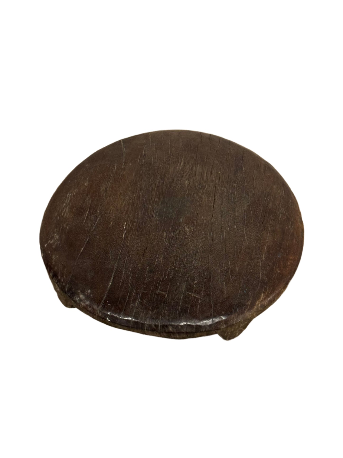The Dark Wood Chapati Board features a round, 13-inch diameter with three short legs. Its dark brown wooden surface shows wear and scratches, and it is displayed isolated on a white background.