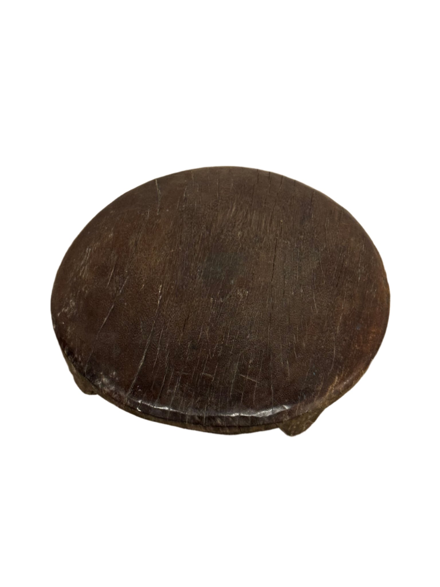 The Dark Wood Chapati Board features a round, 13-inch diameter with three short legs. Its dark brown wooden surface shows wear and scratches, and it is displayed isolated on a white background.