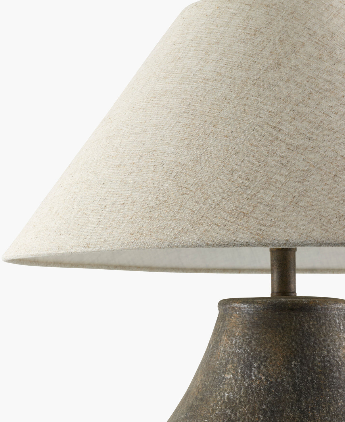 Ceramic and Linen Table Lamp with a textured, dark base and a conical, light-colored fabric shade, resting on a small accent table.