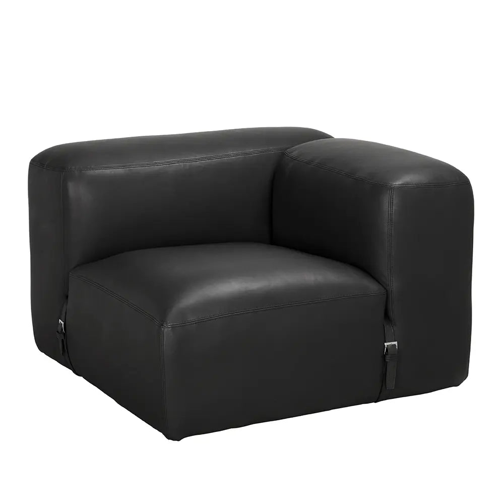The Buckled Black Leather Modular Sofa features a modern, boxy design with rounded edges, wide armrests, and two small metal buckles near the front base, making it a standout minimalist piece.