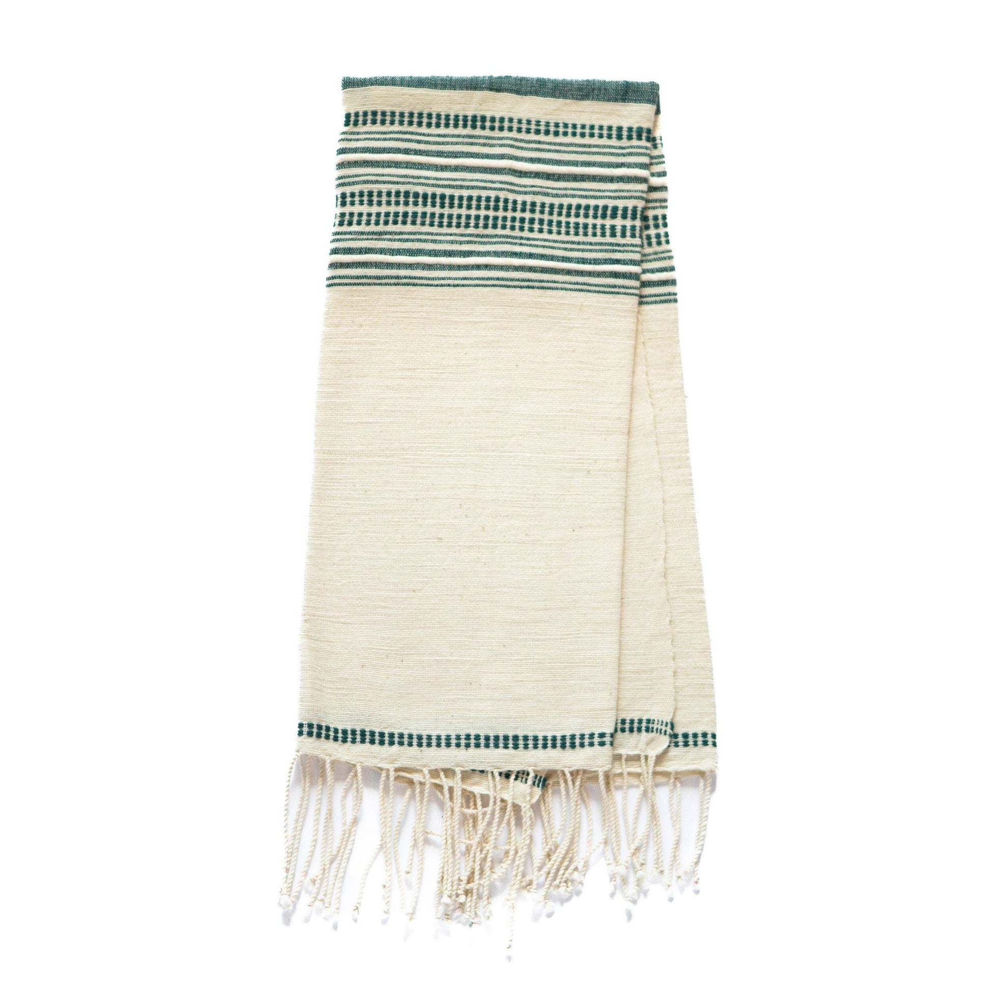 The Handwoven Ethiopian Cotton Hand Towel is a folded beige towel with green and dark blue horizontal stripes near the top and bottom, finished with fringed tassels along the edge.