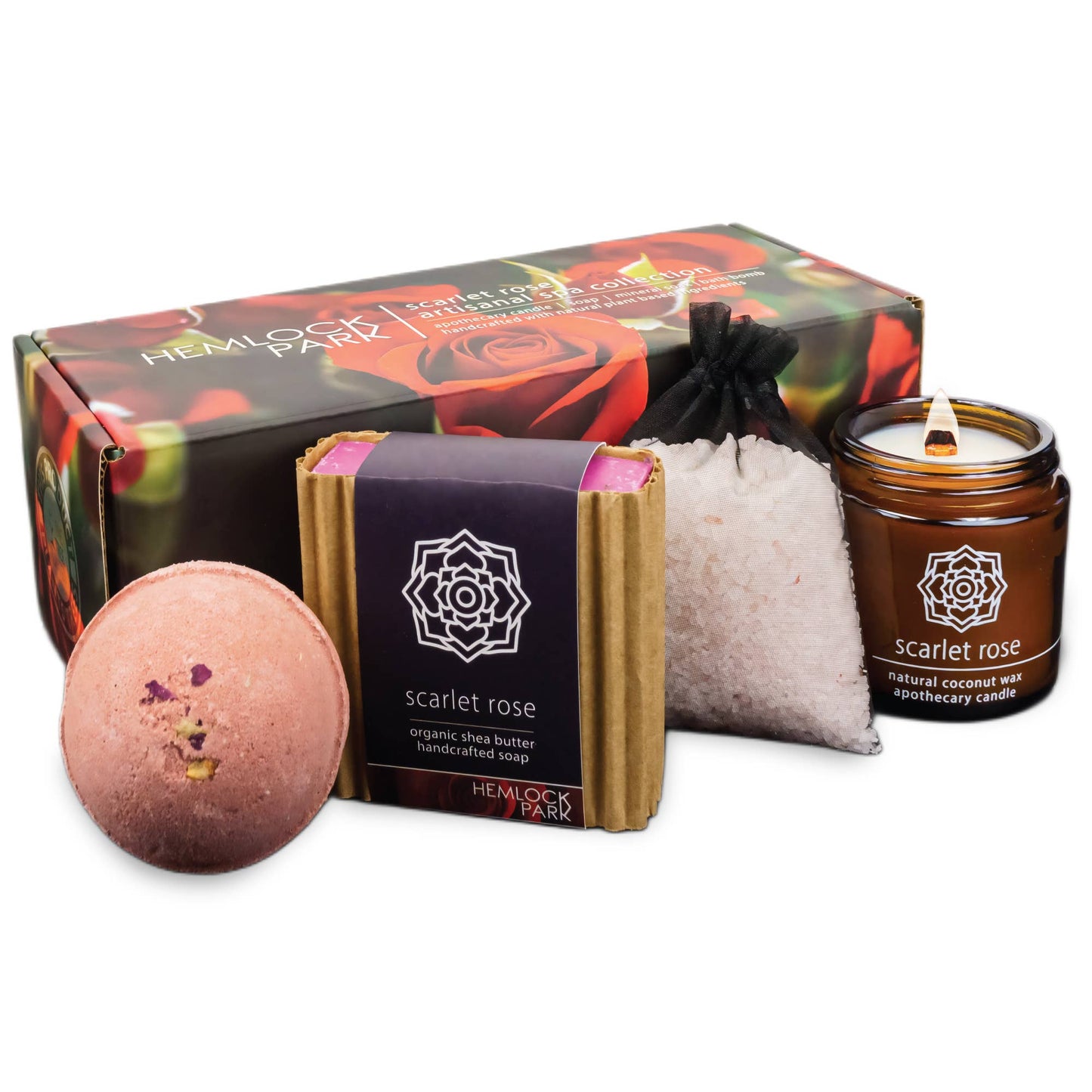 The Artisanal Spa & Candle Gift Box includes a rose-themed box, pink bath bomb, handcrafted soap with organic shea butter, bath salts, and a brown glass candle labeled Scarlet Rose.